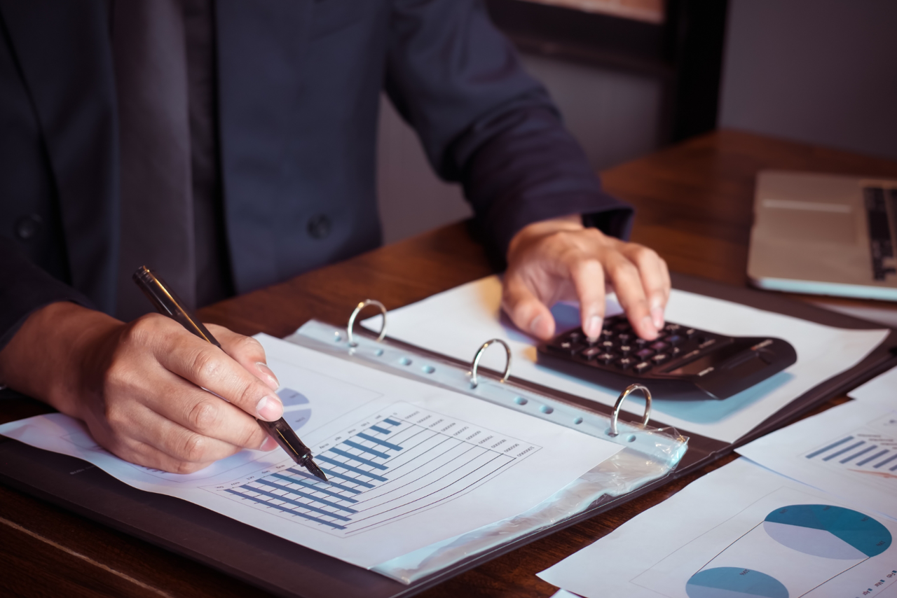 Payroll records and a calculator on a desk